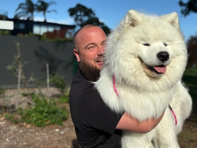 Chris with a dog wearing PK9 gear