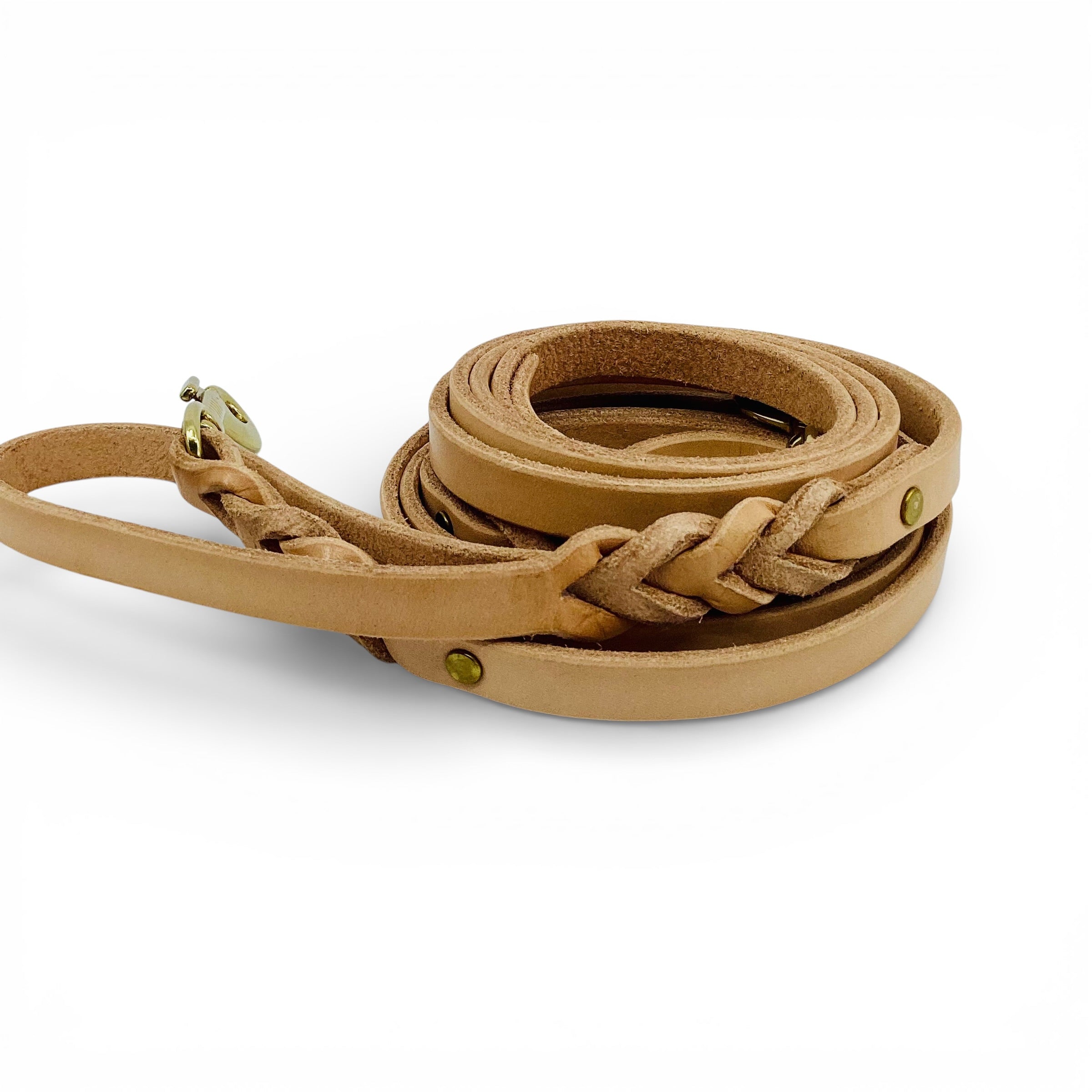 Brown leather dog leash with braided design on a white background