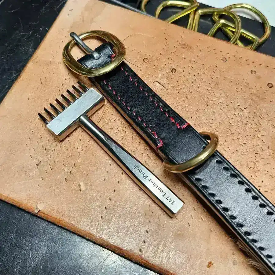 Leather belt with gold buckle on a workbench