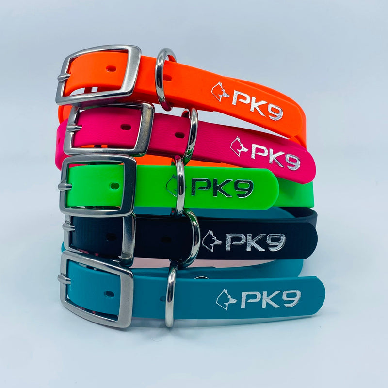 Stack of colorful dog collars with 'PK9' branding on a light gray background