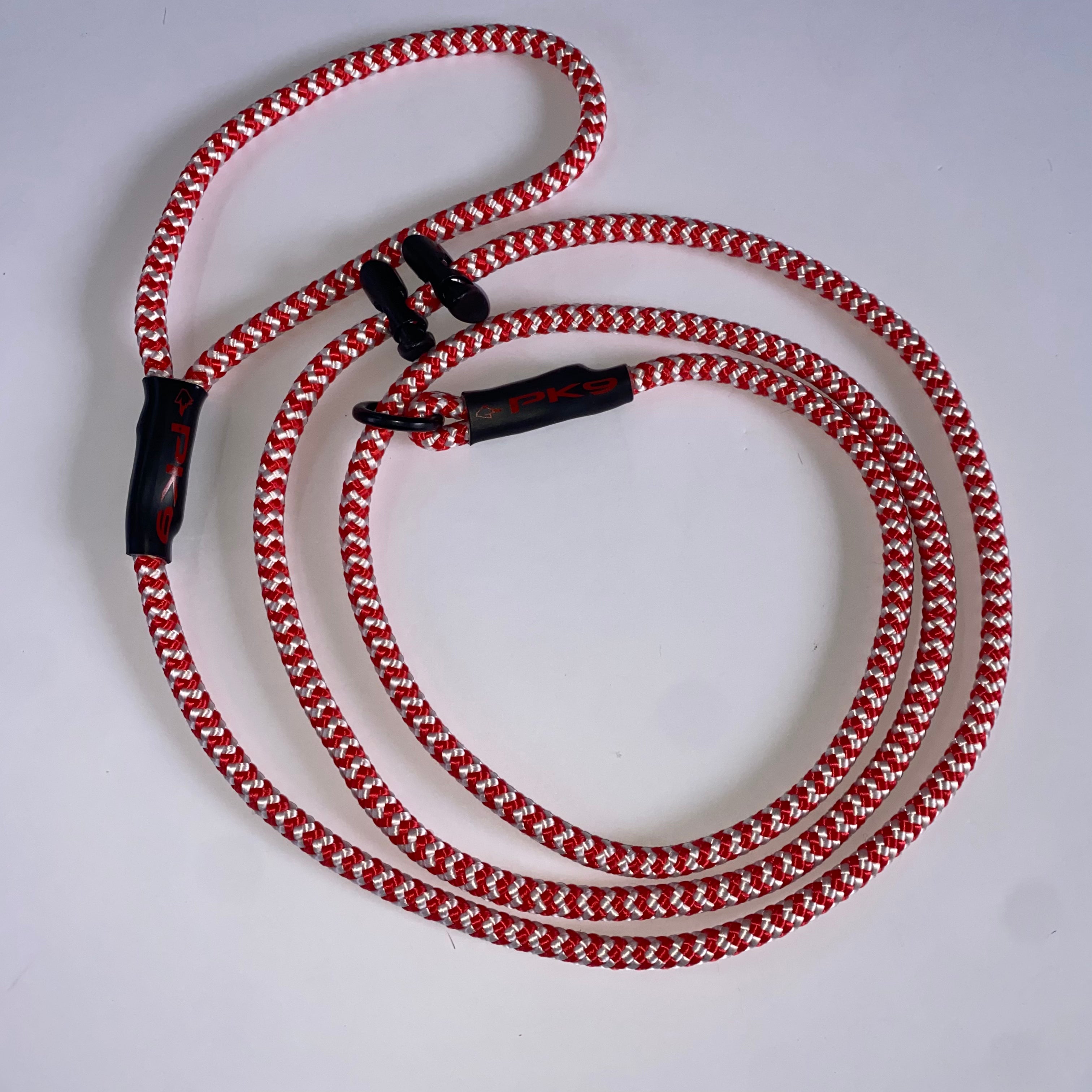Red and white braided cord with black clips on a light gray background