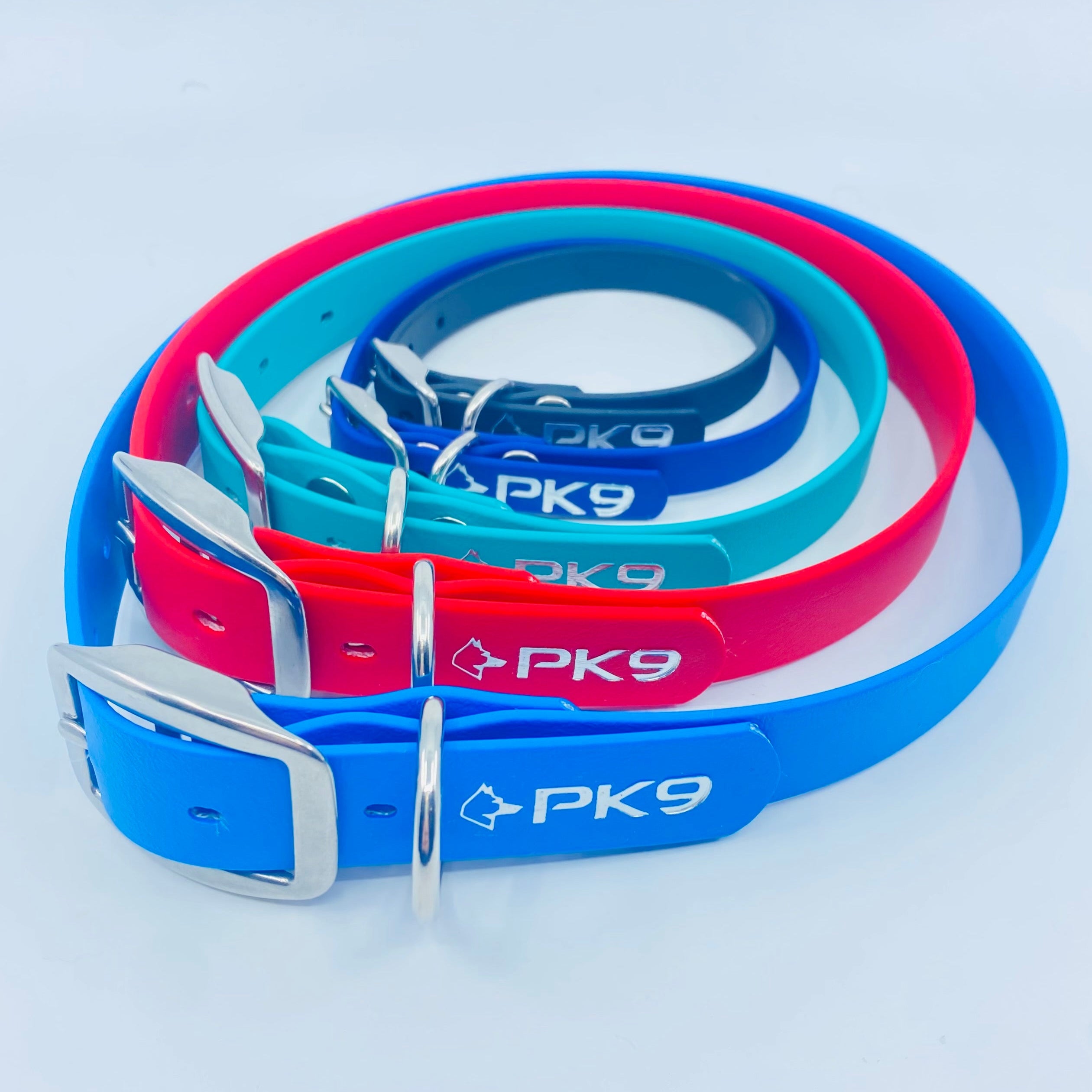 Set of blue and red dog collars with 'PK9' branding on a light gray background