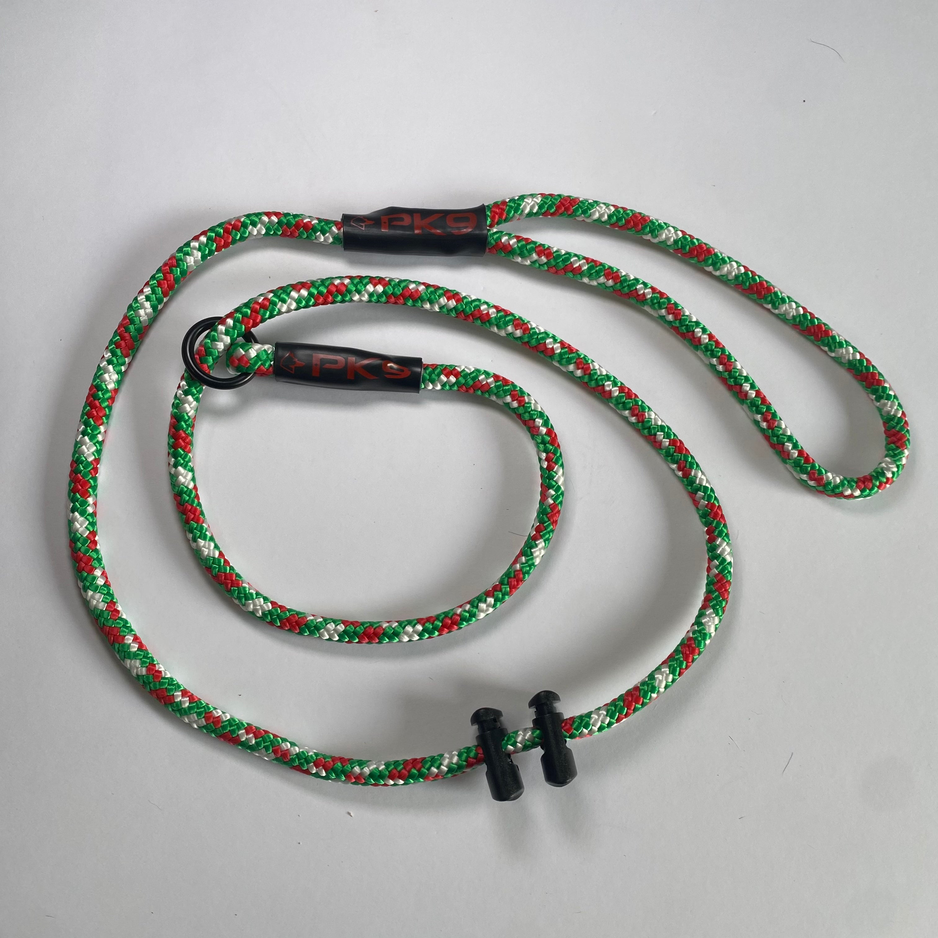 Green and red braided dog leash with black clips on a white background